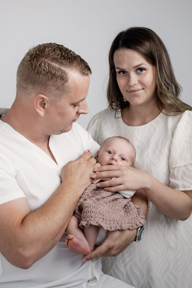 tre børn poseret foran en lys baggrund til en fotografering